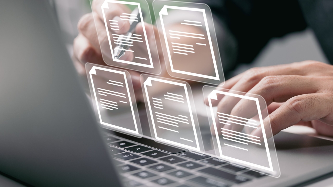 Businessman,Working,On,Laptop,Computer,With,Electronics,Document,Icons,,E-document