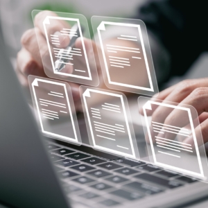 Businessman,Working,On,Laptop,Computer,With,Electronics,Document,Icons,,E-document